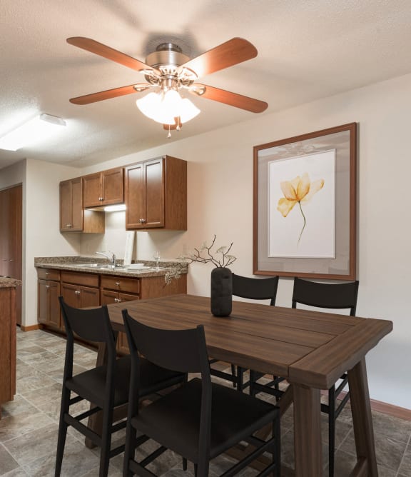 a dining room with a table and chairs