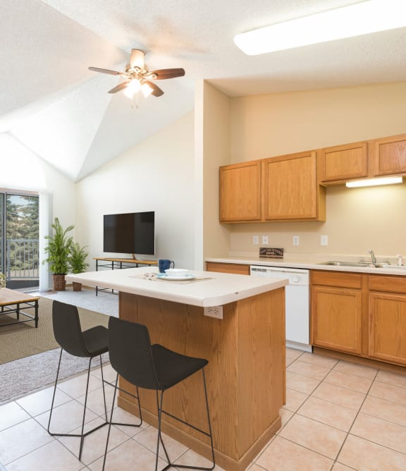 a kitchen with a island and a living room with a couch