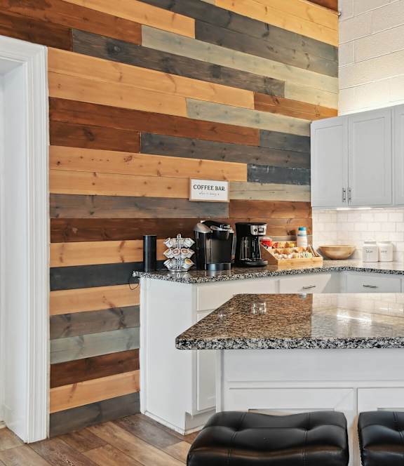 a kitchen with white cabinets and a marble counter top