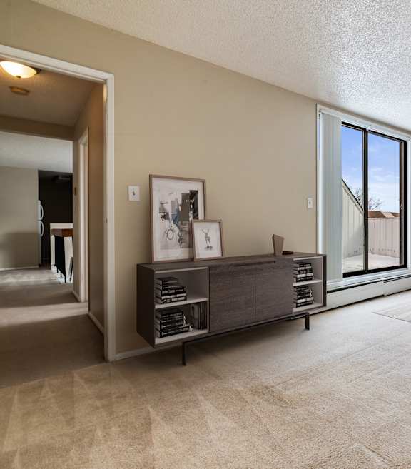 A bedroom with a large bed and a window overlooking a tree.