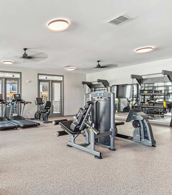 A gym with treadmills, elliptical machines, and other exercise equipment in our Indian Land apartments.