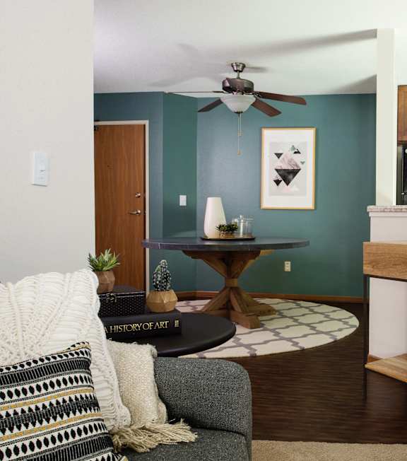 a living room with a couch and a table and a kitchen