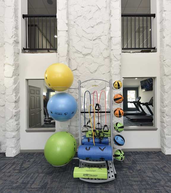 A gym with a blue, green and yellow ball.