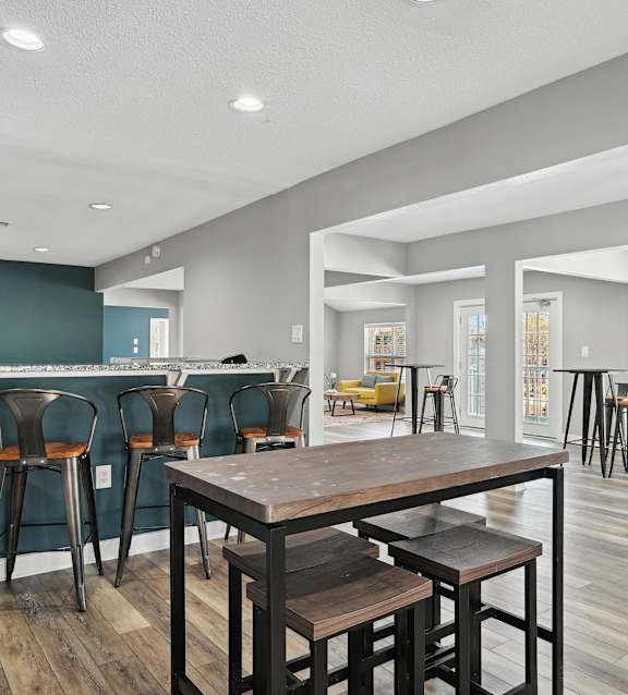 a dining area with a table and chairs and a bar