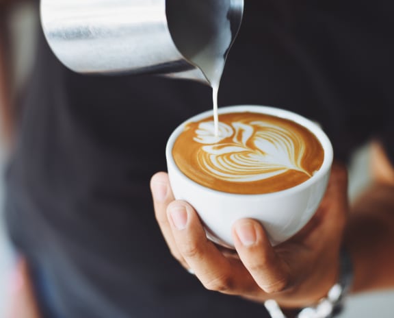 a man holding a cup of coffee