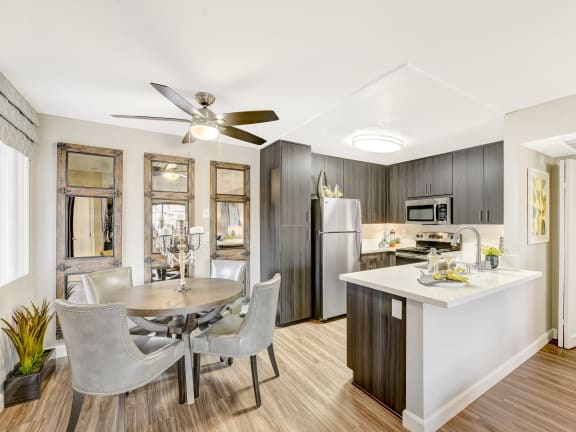 a living room with a kitchen and a dining table