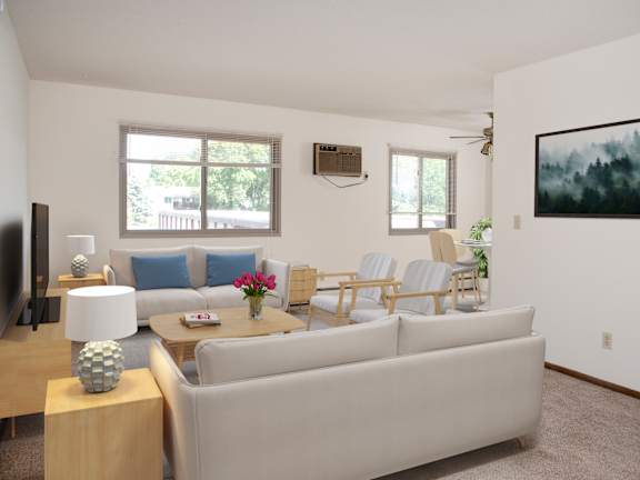 A living room with a white couch, a wooden side table, and a painting on the wall.