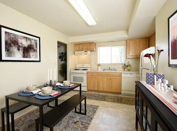 a kitchen and dining room with a table and chairs