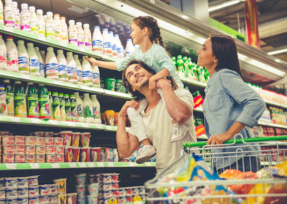 A family of three are shopping in a supermarket.