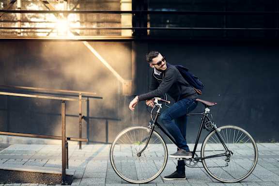 a man riding a bike in front of a building