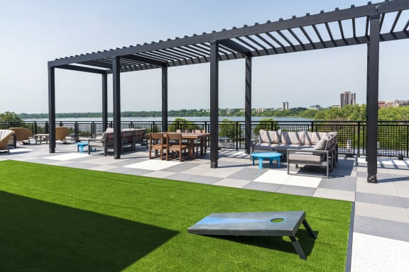 a patio with furniture and a view of a river