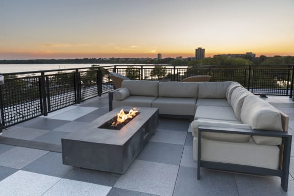 a living room with a couch and a fire pit on a rooftop
