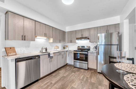 a modern kitchen with stainless steel appliances and wooden floors at Edge At Farmington Hills - Farmington Hills, MI, Farmington Hills, 48334
