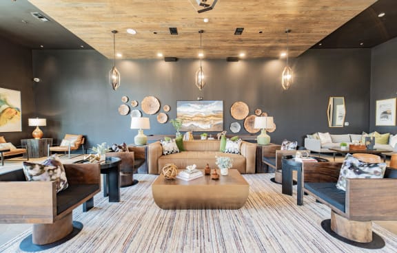 a living room with a couch and chairs and a chandelier