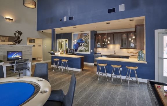 a clubhouse with a pool table and a bar and a kitchen