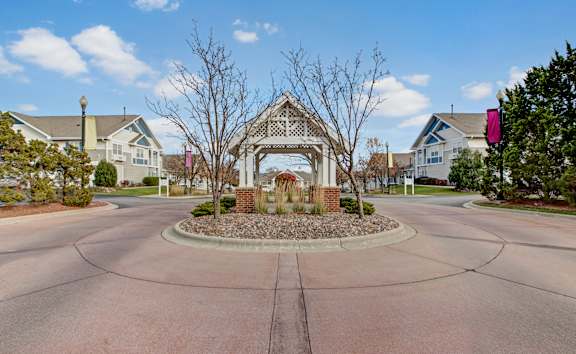 A gazebo is surrounded by a circular driveway.