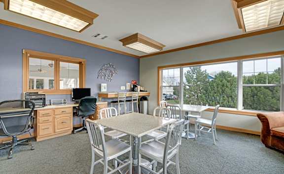 A room with a table and chairs in it.
