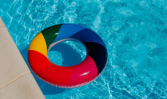a colorful inflatable beach ball in a pool