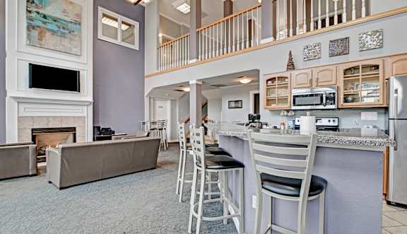 A kitchen with a bar area and a fireplace.