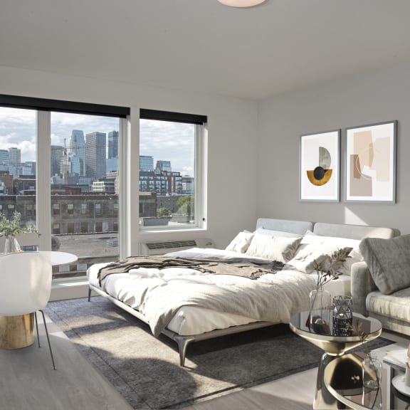 a bedroom with a bed and a view of the city