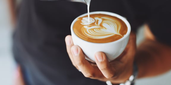 a man holding a cup of coffee