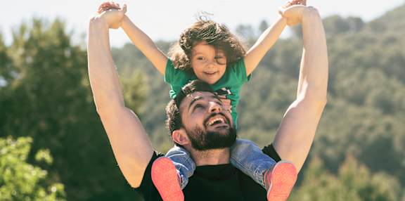 A man lifts a child in the air at The Maddox on Eagle, Oklahoma City, Oklahoma