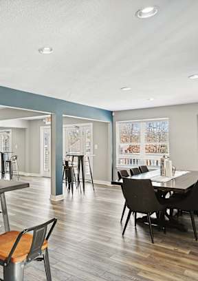 a dining area with tables and chairs and a view of a kitchen and living room  at Emerald Bay, North Carolina