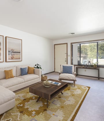 Bismarck, ND Riverpark Apartments The room features large windows that offer scenic views of the surrounding area, comfortable seating, and modern decor. The dark wood trim and furnishings bring the room to life with highly contrasting colors