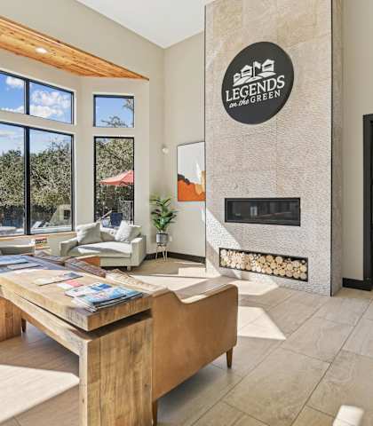 a living room with a fireplace and a wooden table