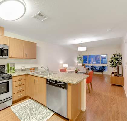 A kitchen with wooden cabinets and a stainless steel oven.