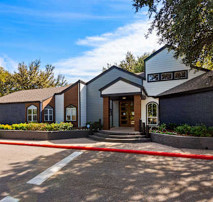 a house with a parking lot in front of it