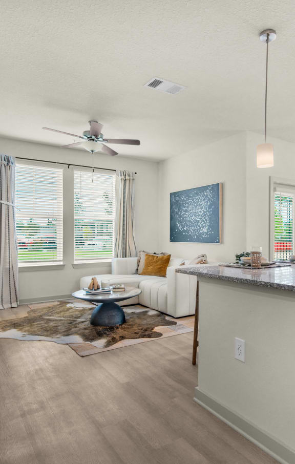 an open living room and kitchen with a ceiling fan at The Enclave at Deer Moss Creek, Florida