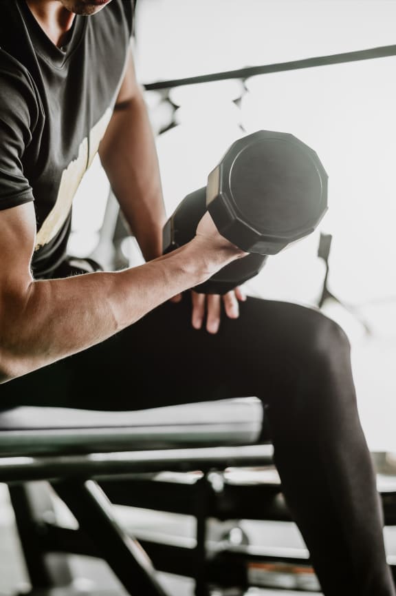 young man at the gym lifting a dumbbell free photo at The Crest at South Point, McDonough, 30253