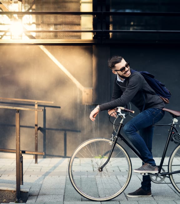 a man standing next to a bike looking at his cell phone