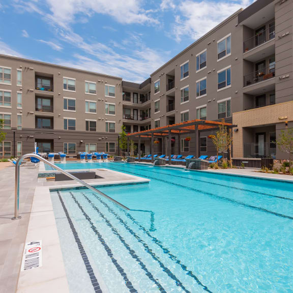 a swimming pool with an apartment building in the background  at Encore at Boulevard One, Colorado, 80230