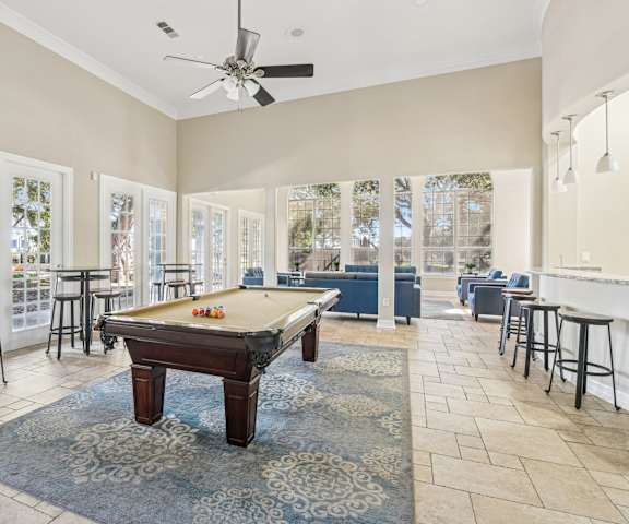 a game room with a pool table and seating areas  at TalaVera Apartments, Texas, 78232