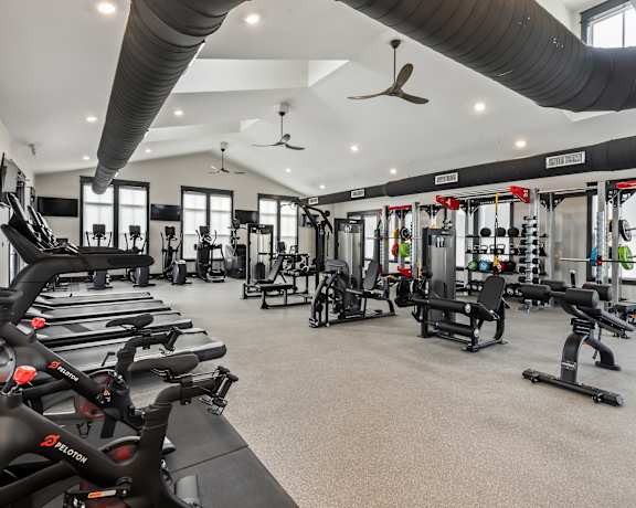 A gym with treadmills, weights, and exercise equipment. at Ovation at Town Madison, Alabama, 35758