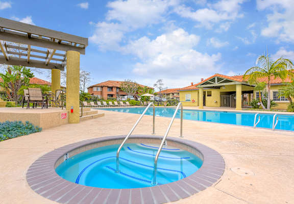 A small round pool with a ladder in the middle.