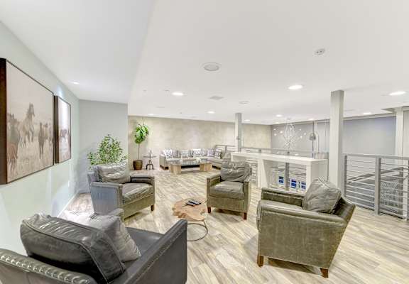 A spacious living room with grey couches and a white coffee table.