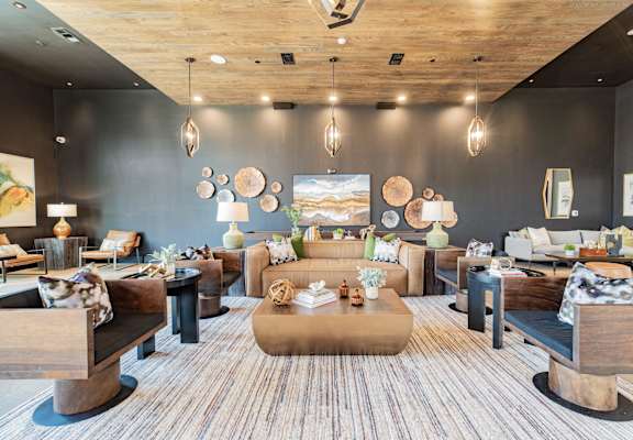 a living room with couches and chairs and a table