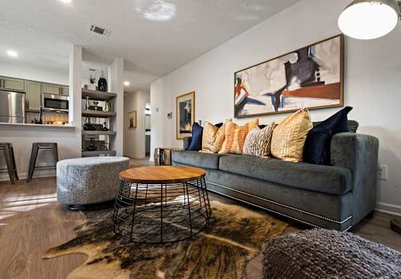 a living room with a gray couch and a gray chair