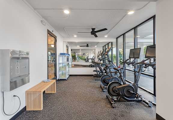 a gym with weights and cardio machines and a water fountain at The Teale Navy Yard, North Charleston, South Carolina