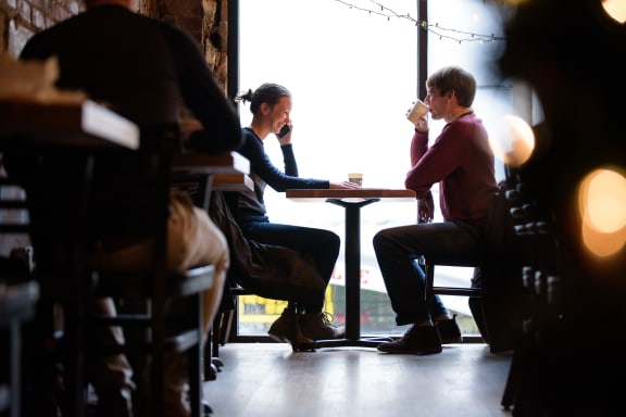 people sitting at a table in a coffee shop