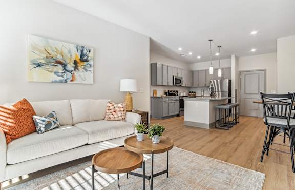 Open concept living room that leads into the kitchen with hardwood floors in our Indian Land apartments.