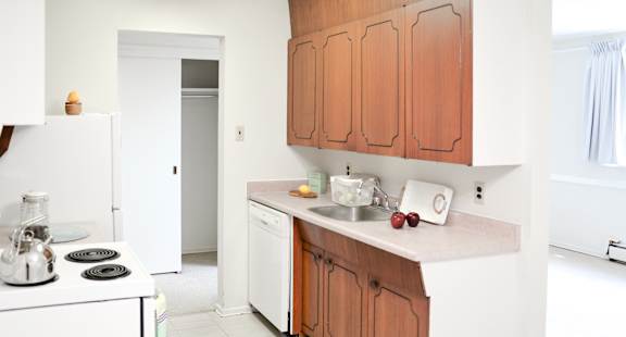 A kitchen with wooden cabinets and white appliances.