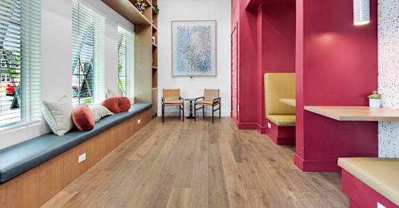a living room with pink walls and a wood floor at The Enclave at Deer Moss Creek, Florida