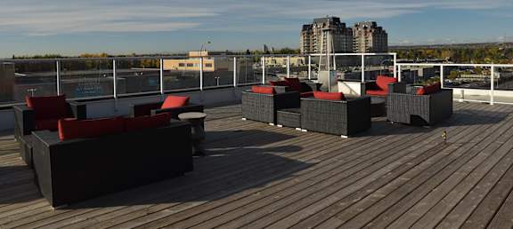 A wooden deck with red cushioned seating.