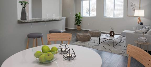 A dining room with a white table and chairs.