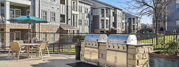 A patio area with a table and chairs is in front of a building.