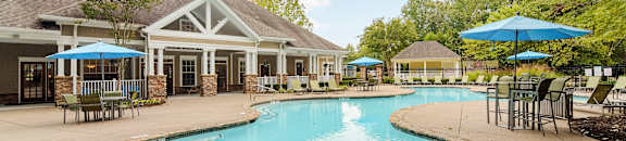 A large swimming pool surrounded by a stone border at Highlands Apartment Homes, Bartlett